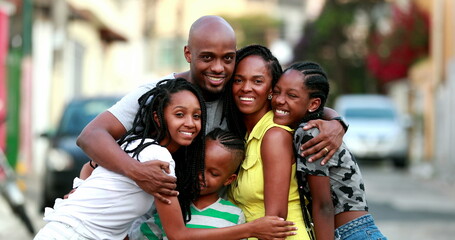 Beautiful black family embrace. Loving father hugging wife and children. African ethnicity