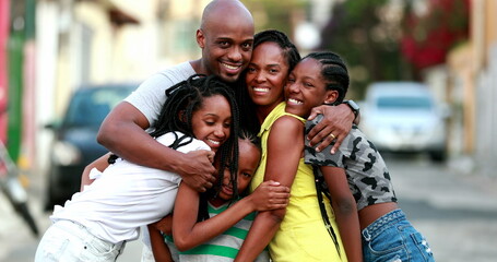 Beautiful black family embrace. Loving father hugging wife and children. African ethnicity