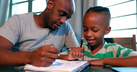 African American father tutoring little boy son