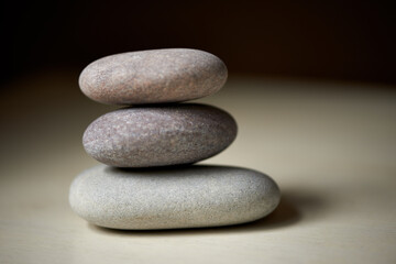 Fototapeta na wymiar Zen balance. Three stones balanced on top of each other in natural light.