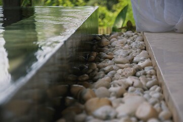 pathway with pebbles besides swimming pool
