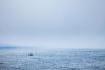 A fishing boat in the fog just off the coast of Cape Flattery, Washington