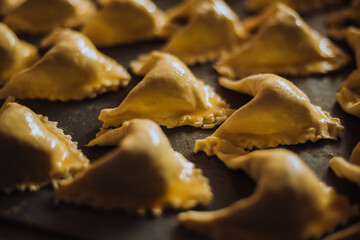 Empanada dough before going into the oven in a dish. Pastry concept, bakery.