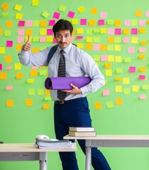 Man in the office with many conflicting priorities preparing go