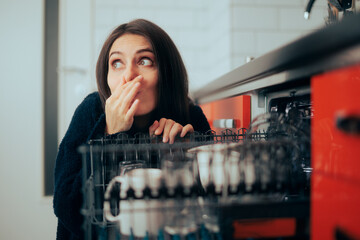 Woman Dealing with Stinky Smell Coming from the Dishwasher  - obrazy, fototapety, plakaty