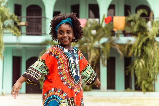 Portrait of a indigenous little black girl wearing traditional clothing.
