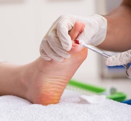 Podiatrist treating feet during procedure