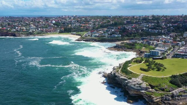 Aerial drone view of iconic Bronte Beach and Tamarama Beach coastline in Sydney, Australia during summer on a sunny day 