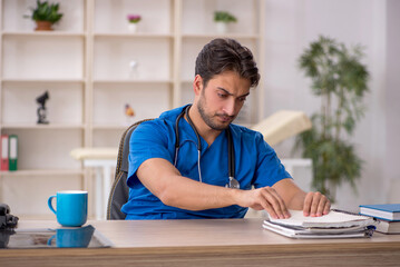 Young male doctor working in the clinic