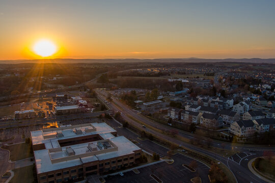 Low level aerial view of Urbana, Frederick County, Maryland at sunset.	