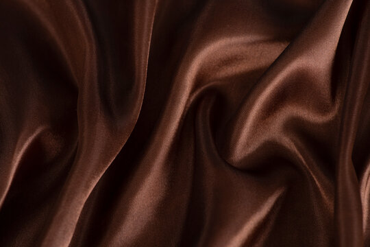 Smooth elegant brown silk or satin texture can use as abstract background.