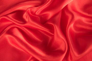 Fototapeta na wymiar Abstract red silk fabric texture background. Cloth soft wave.