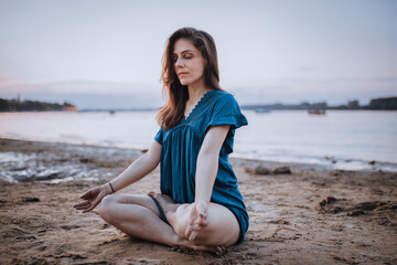 Fototapeta na wymiar Woman meditating yoga lotus pose at morning. Travel Lifestyle relaxation emotional concept summer vacations outdoor harmony with nature calm scene