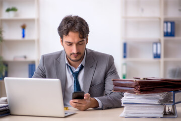 Fototapeta premium Young male employee in oversleeping concept
