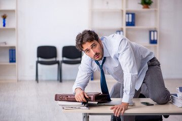 Young male employee in oversleeping concept