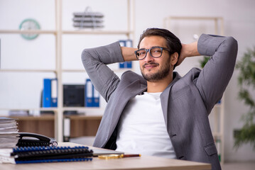 Young male employee working in the office