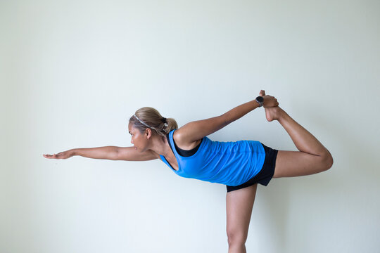 Young woman doing yoga asana standing bow pose Vector Image