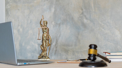 Justice Scales concept of judges and lawyers and a book and a wooden hammer with a laptop on the table. Justice