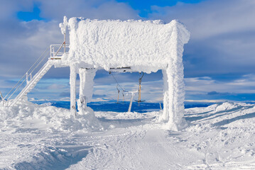 frozen funicular support poles over clouds. ski lift technology in winter, ski resort, mountain...