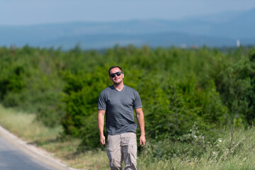 Portrait of Muscular Man Standing Outdoors at Highway