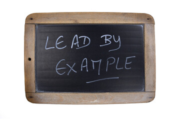 Fototapeta premium inscription in English lead by example on a slate on a white background