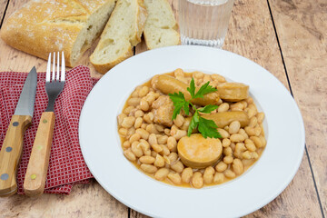 top view of a plate of cassoulet on a wooden table