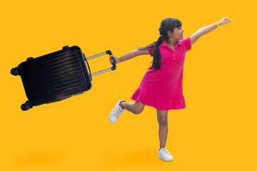 Asian little girl wearing pink mini dress in summer isolated on yellow orange background. Passenger traveling abroad to travel on weekends getaway. Air flight journey in end of semester in summer.