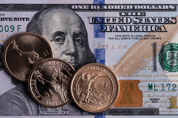 100 american dollars and 1 dollar coin
