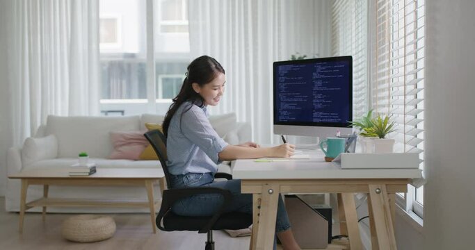 New possible digital transformation workforce. Asia young woman happy work at home office self cheering success reskill upskill job done remote test on desktop AI design online and cyber security.