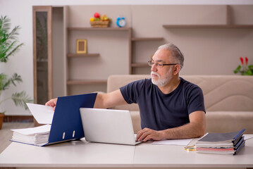 Old male employee working from home during pandemic