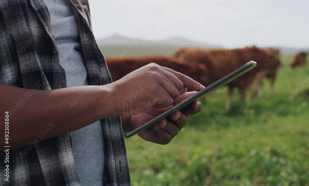 Poster agricultural management gets an upgrade. shot of an unrecognisable man using a digital tablet while 