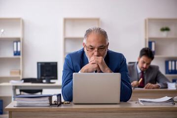 Two male colleagues working in the office