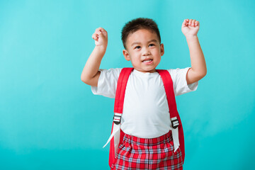 Back to school. Portrait happy Asian cute little child boy in uniform smile raise hands up glad...