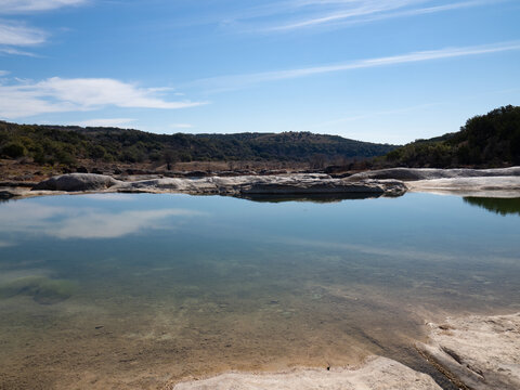 Pool of Clear Water in the Pedernales River with Reflections of Clouds in Pedernales Falls State Park