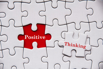Positive thinking text on missing jigsaw puzzle. Motivational and inspirational concept