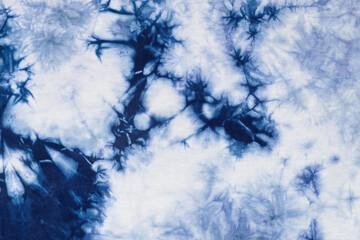 Close-up batik shirt with indigo blue dye on white fabric cotton background on top-view