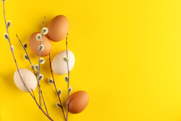 brown and white fresh farm eggs decoration for easter holiday on yellow background top view