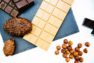 White chocolate and brownies with nuts on a gray background. flat lay frame