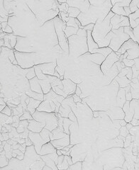 Cracked white paint on the wall as an abstract background.