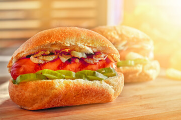 Hot dogs on wooden board in sunny cafe