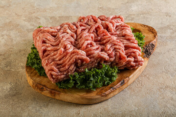 Raw pork minced meat over board