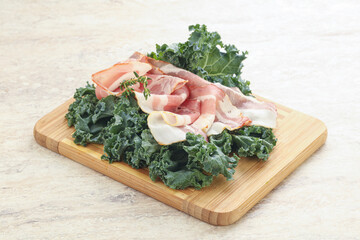 Raw pork bacon over board