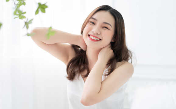 Image of young Asian woman in bed