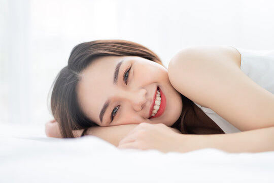 Image of young Asian woman in bed