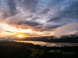 Fototapeta premium Sunrise over The Mountain with The River and The Fog