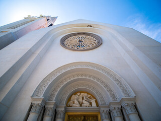 Obraz premium Golden Door with Roman Columns in Front of t.Louis Marie de Montfort Church