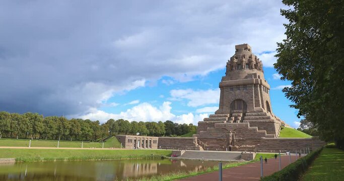 Leipzig, Germany - September 23, 2021: Time lapse at the monument of the battle of nations in the saxony city of Leipzig. Napoleon's downfall began at this point. The building behind a small pond