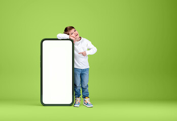 A kid point at smartphone mockup display on bright background