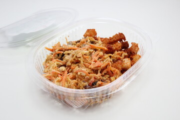 Spicy salad in a plastic disposable package. Salad of carrots, chicken, crackers, cheese, mayonnaise.