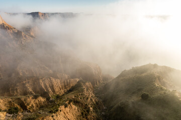 clay ravines, covered in fog, called the barrancas del burujon in Toledo